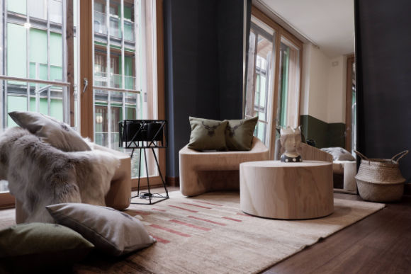 Monica Mariz le albere riva soggiorno con sedute in legno e tappeto